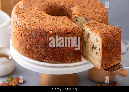 Pecan caramel pound cake baked in a bundt pan, homemade and served on a cake stand sliced Stock Photo