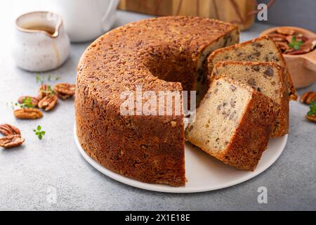 Pecan caramel pound cake baked in a bundt pan, homemade and served on a cake stand sliced Stock Photo