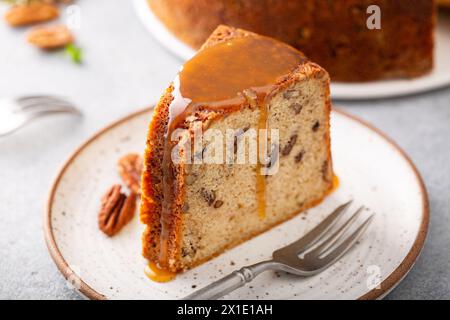 Pecan caramel pound cake baked in a bundt pan, homemade and slice served on a plate Stock Photo