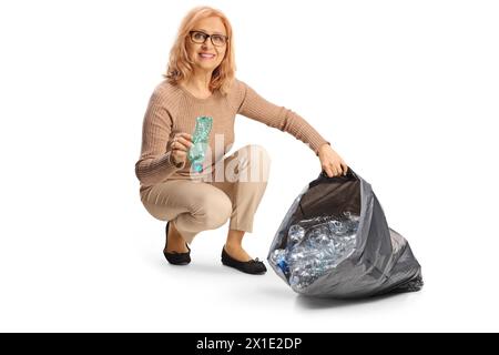 Woman collecting plastic bottles for recycling isolated on white background Stock Photo