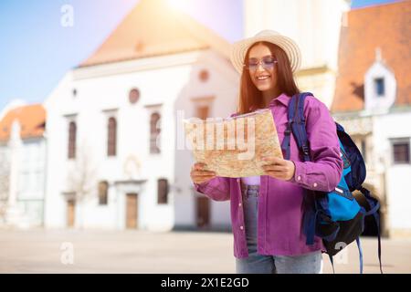 Traveling student reading a map in sun Stock Photo