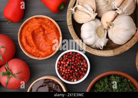 Different fresh marinades in bowls and ingredients on grey wooden table, flat lay Stock Photo