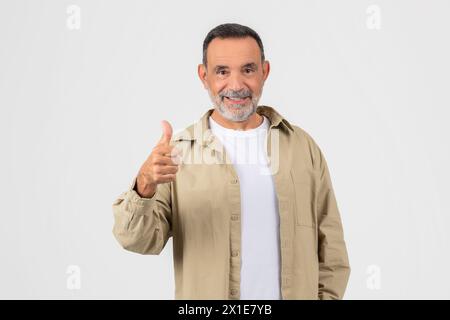Senior man giving thumbs up with a smile Stock Photo