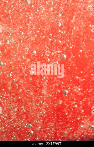 Bubbles of water on a red background closeup Stock Photo