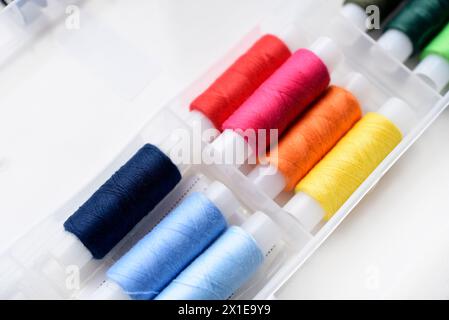 Multicolored skeins of thread in the set. The threads are in a plastic box. Stock Photo