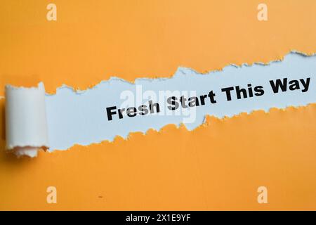 Concept of Fresh Start This Way Text written in torn paper. Stock Photo
