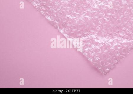 Transparent bubble wrap on pink background, top view. Space for text Stock Photo