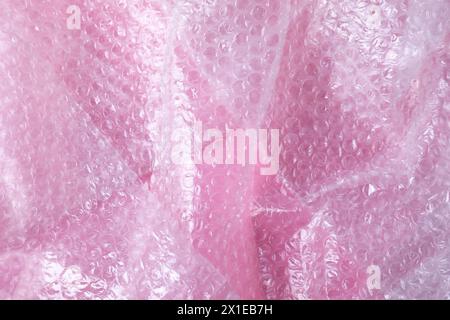 Transparent bubble wrap on pink background, top view Stock Photo