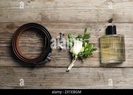Wedding stuff. Flat lay composition with stylish boutonniere on wooden table Stock Photo
