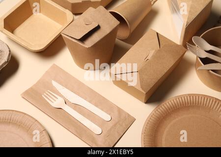 Eco friendly food packaging. Paper containers and tableware on beige background Stock Photo