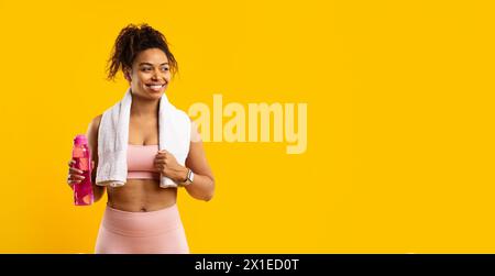 Happy Black woman with a towel and water bottle for her workout Stock ...