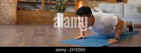 Strong asian mature man making strength workout at home Stock Photo