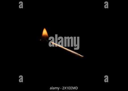 Lit and falling match on a black background. Stock Photo