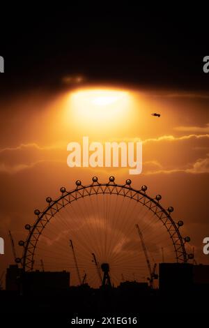 London, UK. 16th April 2024. UK Weather: Dramatic sunset over London near London Eye ferris wheel ending a stormy Tuesday which saw rain and hail hit the city. Credit: Guy Corbishley/Alamy Live News Stock Photo