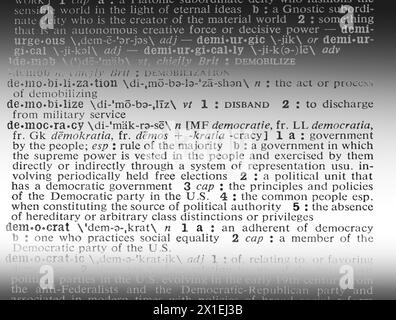 The Webster's Seventh New Collegiate Dictionary shows the word 'democracy,' near  'democrat,' and 'democratic,' the opposite of 'authoritarianism.' Stock Photo