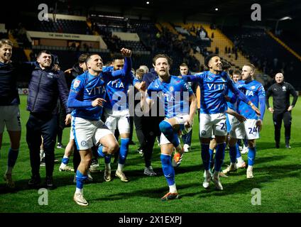Stockport County players celebrate winning the League Two title following the Sky Bet League Two match at Meadow Lane, Nottingham. Picture date: Tuesday April 16, 2024. Stock Photo