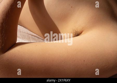Challenge beauty standards and celebrate natural authenticity with this empowering image of a female armpit adorned with hair Stock Photo