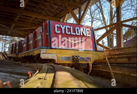 An abandoned roller coaster ride stands frozen in time Stock Photo