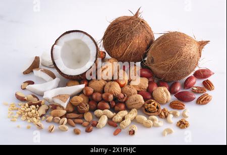 Assorted nuts, including hazelnuts, walnut, brazil nuts, almonds, peanuts, pistachios, pine kernels, coconut and pecan nuts. Stock Photo
