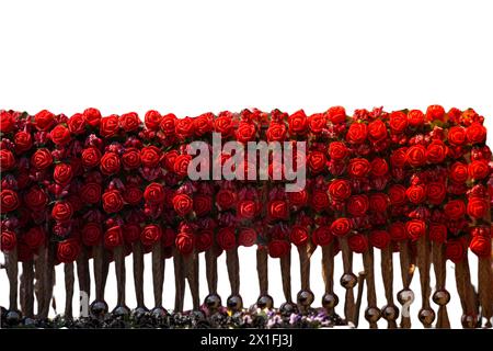There are fake textile flowers on the crown. Colorful isolated crowns for sale made of fake flowers Stock Photo