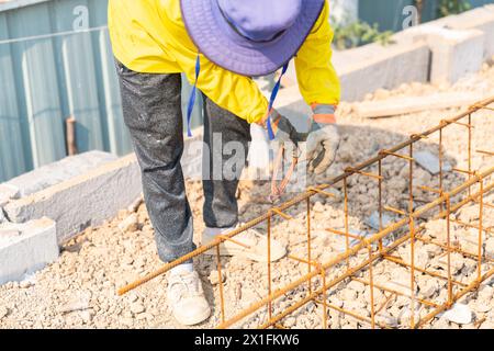 Cutting nipps steel fixer pliers holding on construction worker hand while his hand wear a gloves. Stock Photo