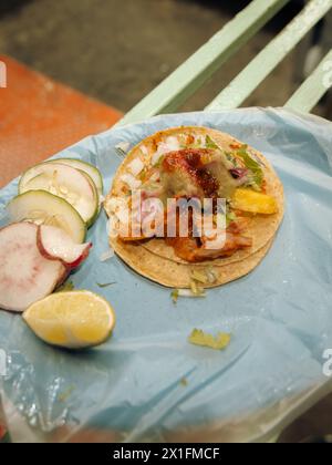 Top down view of a single Mexican al pastor street taco with cilantro, onion, and pineapple. Stock Photo