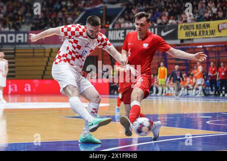 Zagreb, Croatia. 16th Apr, 2024. Antonio Sekulic (L) of Croatia vies for the ball against Pawel Kaniewski of Poland during the Futsal World Cup elite Round play-off 2nd leg match between Croatia and Poland in Zagreb, Croatia, on April 16, 2024. Credit: Luka Stanzl/PIXSELL via Xinhua/Alamy Live News Stock Photo