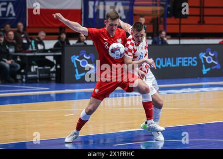 Zagreb, Croatia. 16th Apr, 2024. David Mataja (R) of Croatia vies against Mateusz Madziag of Poland during the Futsal World Cup elite Round play-off 2nd leg match between Croatia and Poland in Zagreb, Croatia, on April 16, 2024. Credit: Luka Stanzl/PIXSELL via Xinhua/Alamy Live News Stock Photo