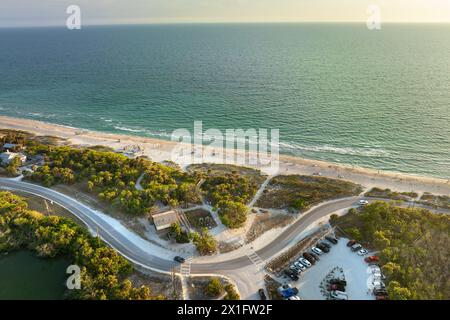 Parking lot at Blind Pass beach on Manasota Key in Englewood. Tourists cars in front of ocean beach with soft white sand in Florida. Popular vacation Stock Photo