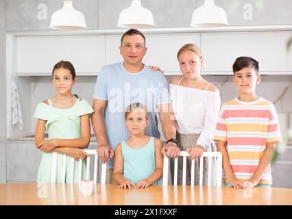 Portrait of best dad who spends his free time with cute, adorable kids in bright modern home kitchen Stock Photo