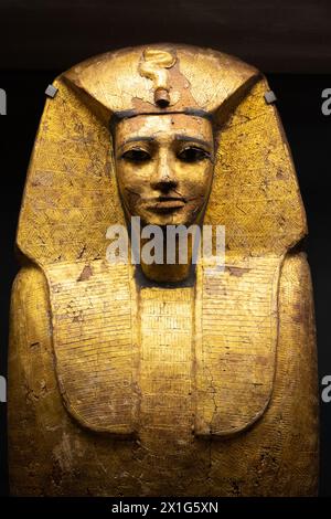 An ancient Egyptian sarcophagus on display, showcasing intricate golden hieroglyphics and craftsmanship. Louvre Museum in Paris, France Stock Photo