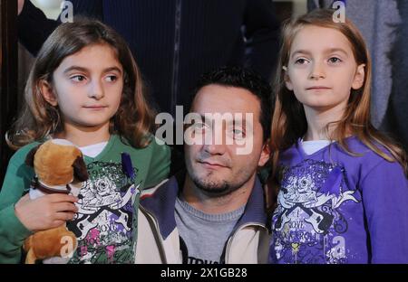 Kosovar father August Komani (C) and his eight-year-old daughters Daniella and Dorentina Komani in a press conference of the association 'Purple Sheep' after they returned to Austria after they were deported earlier this month, on 22 October 2010. The deportation and the fact that the girls were taken into custody before deportation has sparked debate, with critics calling the move heartless and inhumane. - 20101022 PD0669 - Rechteinfo: Rights Managed (RM) Stock Photo