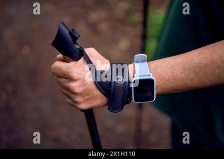 an old woman uses a fitness bracelet Stock Photo