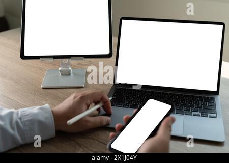 A businessman in an office uses a tablet to work online desktop computer of the blank screen Stock Photo