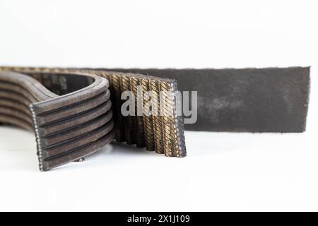 Torn timing belt and generator rivulet belt on a white background. Broken belts in the car, industry Stock Photo