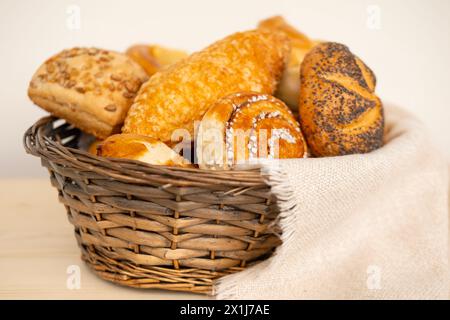 delightful assortment of freshly homemade baked pastries, including cheese buns, poppy seed buns, rolls, savory pretzels and sweet curd tarts in tradi Stock Photo