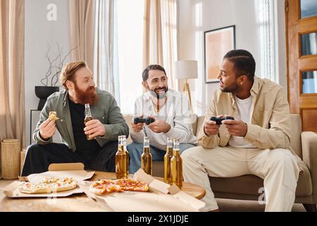 Three cheerful, handsome men of different ethnicities in casual attire, bonding over video games at home. Stock Photo