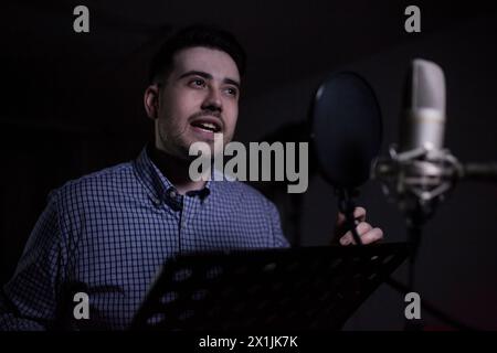 male dub actor performing in dubbing room Stock Photo