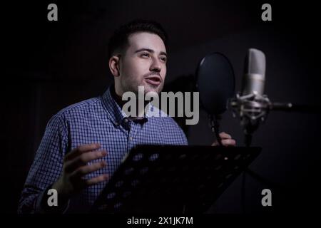 male dub actor performing in dubbing room Stock Photo