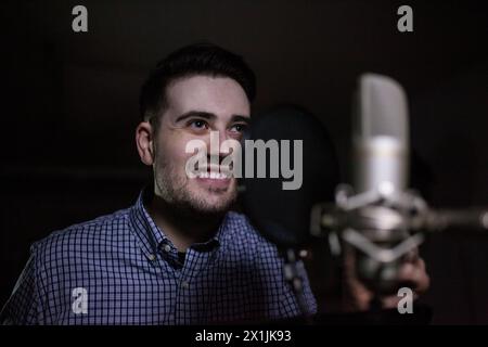 male dub actor performing in dubbing room and smile Stock Photo