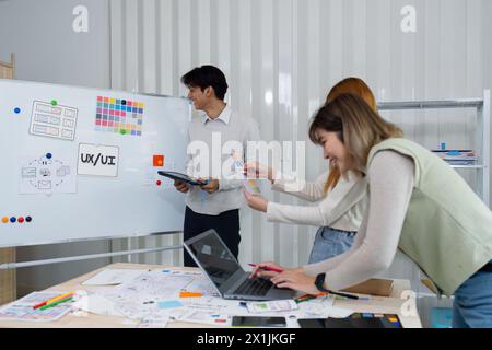 UI designers present to team about color design of logo during application design brainstorming. Creative digital development agency. UX UI concept Stock Photo