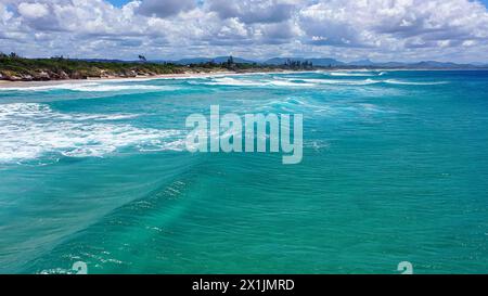Ocean waves with white foam before storm. Windy dangerous weather with cloudy sky. Drone photo Stock Photo