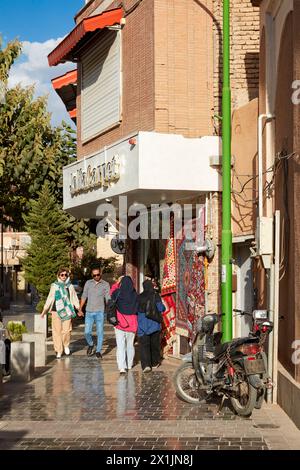 People walk along a narrow street in the New Julfa, Armenian Quarter of Isfahan, Iran. Stock Photo