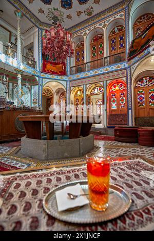 Ornate interior of a small cafe with stained glass windows in the Mollabashi Historical House. Isfahan, Iran. Stock Photo