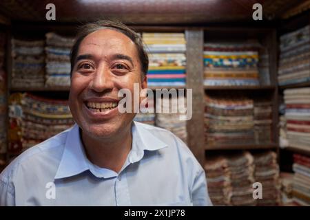 Portrait of a grinning Iranian handicraft seller who looks like once popular French comic actor Fernandel (Fernand Contandin). Isfahan, Iran. Stock Photo