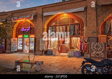 Windows of handicraft shops in Naqsh-e Jahan Square illuminated at dusk. Isfahan, Iran. Stock Photo