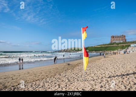 A Red and Yellow safety flag on Fistral Beach in Newquay in Cornwall in the UK. Stock Photo