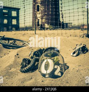 Bizarre jar with plant in desolate and desert city. Destroyed and polluted city. Stock Photo