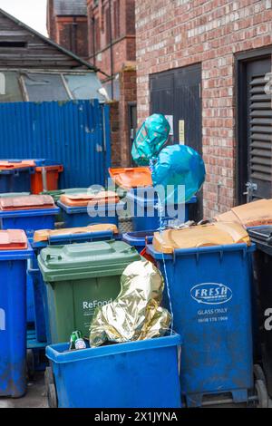 Balloons floating out of commercial rubbish bins in Knutsford England Stock Photo