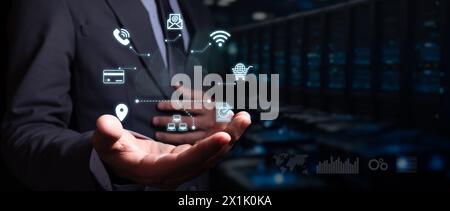 cloud storage concept. executive holds hologram of digital cloud with business icons. blurred dark server background. Stock Photo